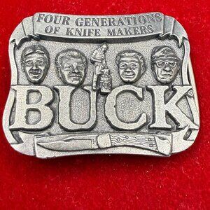 VTG Buck Knives belt buckle representing four generations of the Buck family.